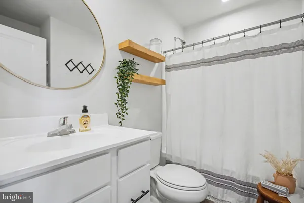 a bathroom with a sink a mirror and a toilet