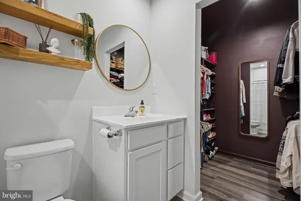 a bathroom with a sink a toilet and a mirror