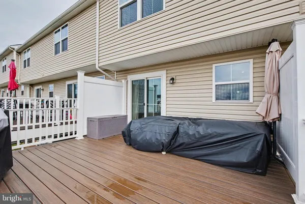 a view of a house with wooden deck