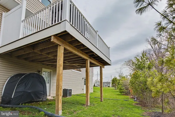 a view of backyard with deck and garden