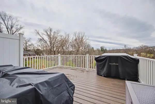 a balcony with wooden floor and fence