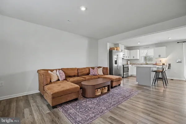 a living room with furniture and kitchen view