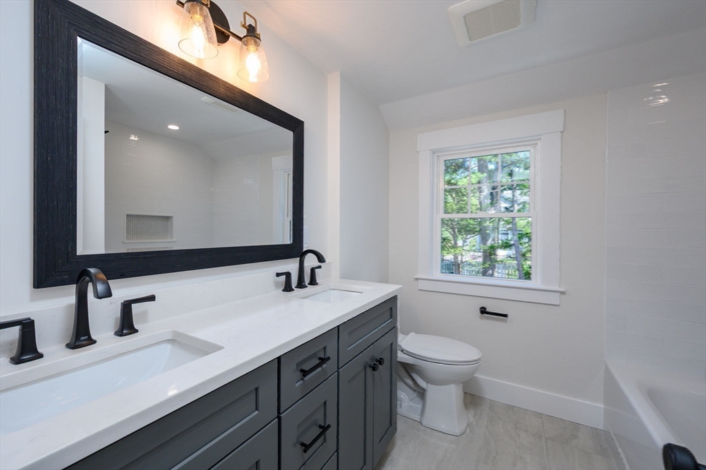 3 Patriots Way Hingham, MA 02043 - Photo 26 of 39 a bathroom with a double vanity sink toilet mirror and window
