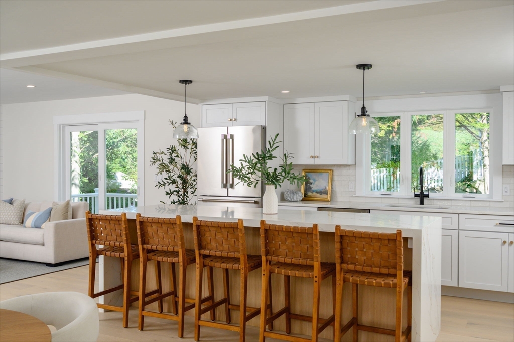3 Patriots Way Hingham, MA 02043 - Photo 7 of 39 a kitchen with stainless steel appliances granite countertop sink stove and white cabinets with wooden floor
