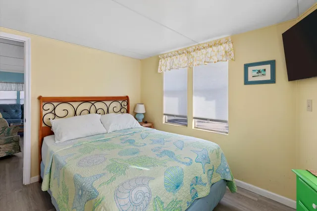 a large bed sitting in a bedroom next to a window