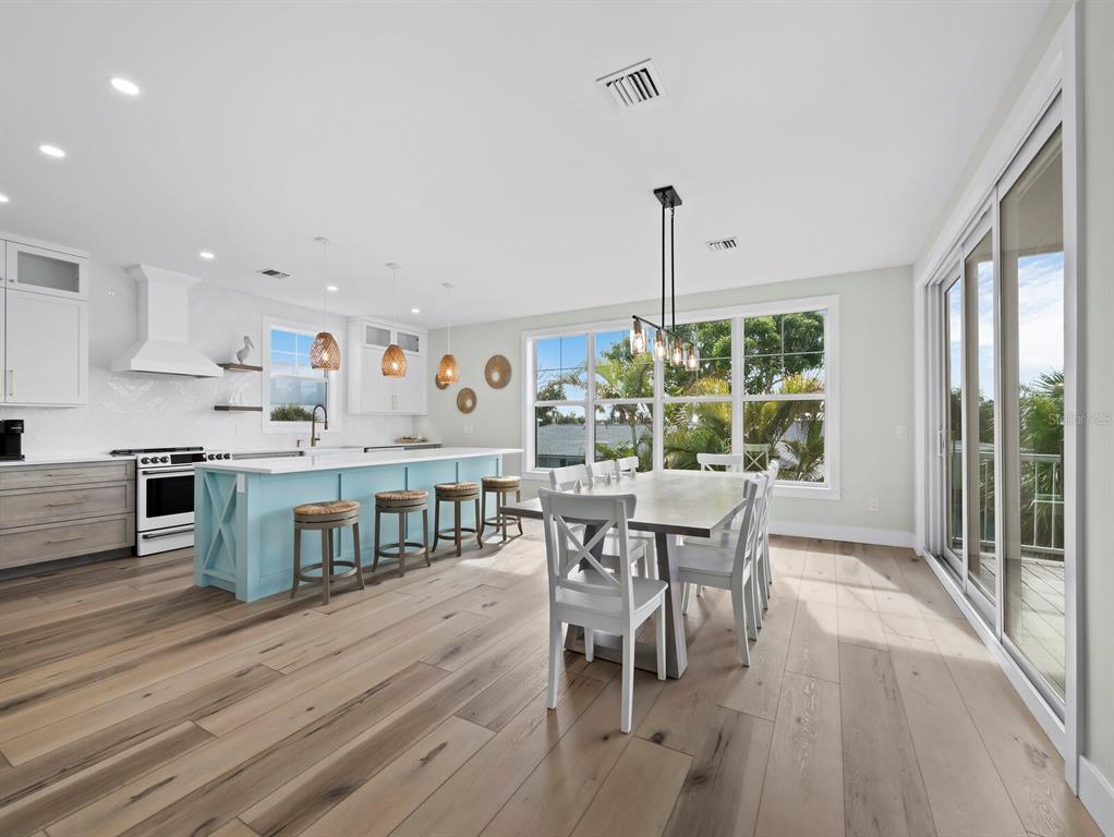 630 Companion Way Longboat Key, FL 34228 - Photo 11 of 66 a dining room with furniture and wooden floor