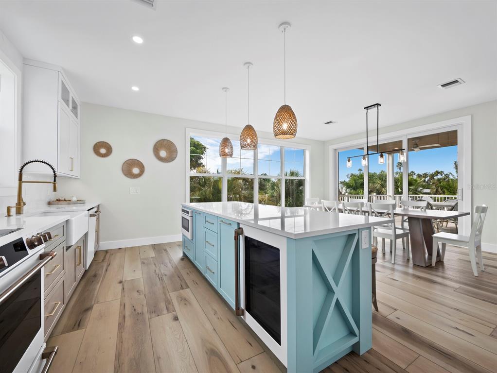 630 Companion Way Longboat Key, FL 34228 - Photo 16 of 66 a kitchen with stainless steel appliances granite countertop a stove and a wooden floors