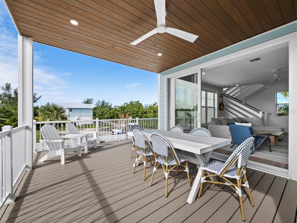 630 Companion Way Longboat Key, FL 34228 - Photo 19 of 66 a view of a patio with table and chairs and wooden floor
