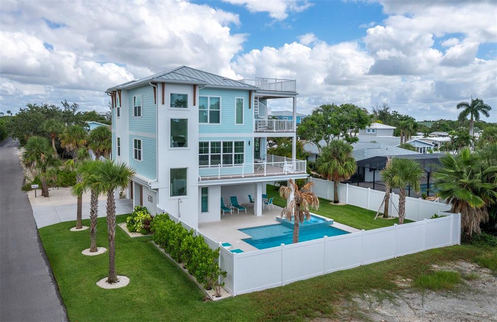 630 Companion Way Longboat Key, FL 34228 - Photo 2 of 66 a front view of a house with garden