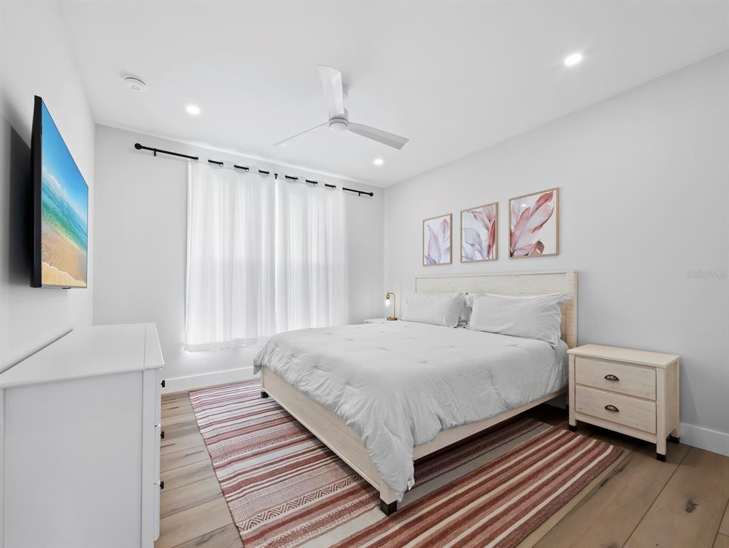 630 Companion Way Longboat Key, FL 34228 - Photo 22 of 66 a bedroom with a bed and a flat screen tv