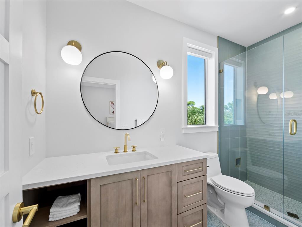 630 Companion Way Longboat Key, FL 34228 - Photo 23 of 66 a bathroom with a sink a toilet and a mirror