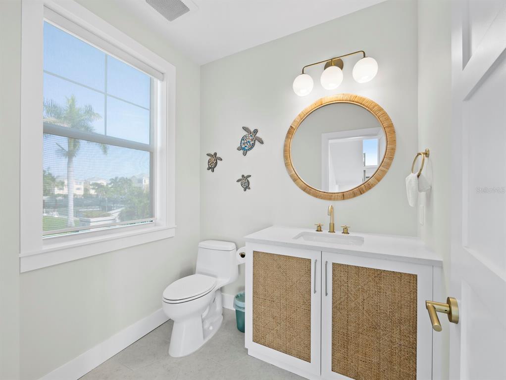 630 Companion Way Longboat Key, FL 34228 - Photo 25 of 66 a bathroom with a sink a toilet and a mirror