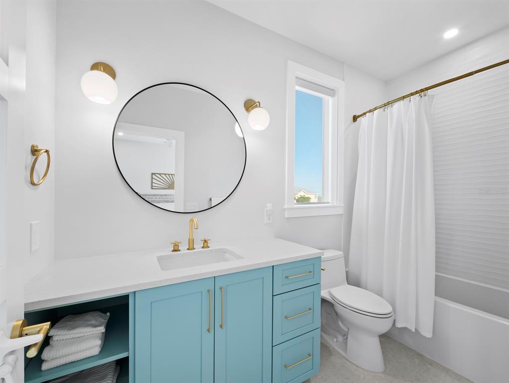 630 Companion Way Longboat Key, FL 34228 - Photo 28 of 66 a bathroom with a sink a mirror a toilet and a window