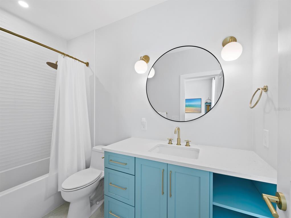 630 Companion Way Longboat Key, FL 34228 - Photo 31 of 66 a bathroom with a sink a toilet and a mirror