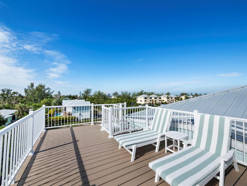 630 Companion Way Longboat Key, FL 34228 - Photo 43 of 66 a view of a balcony with wooden chairs