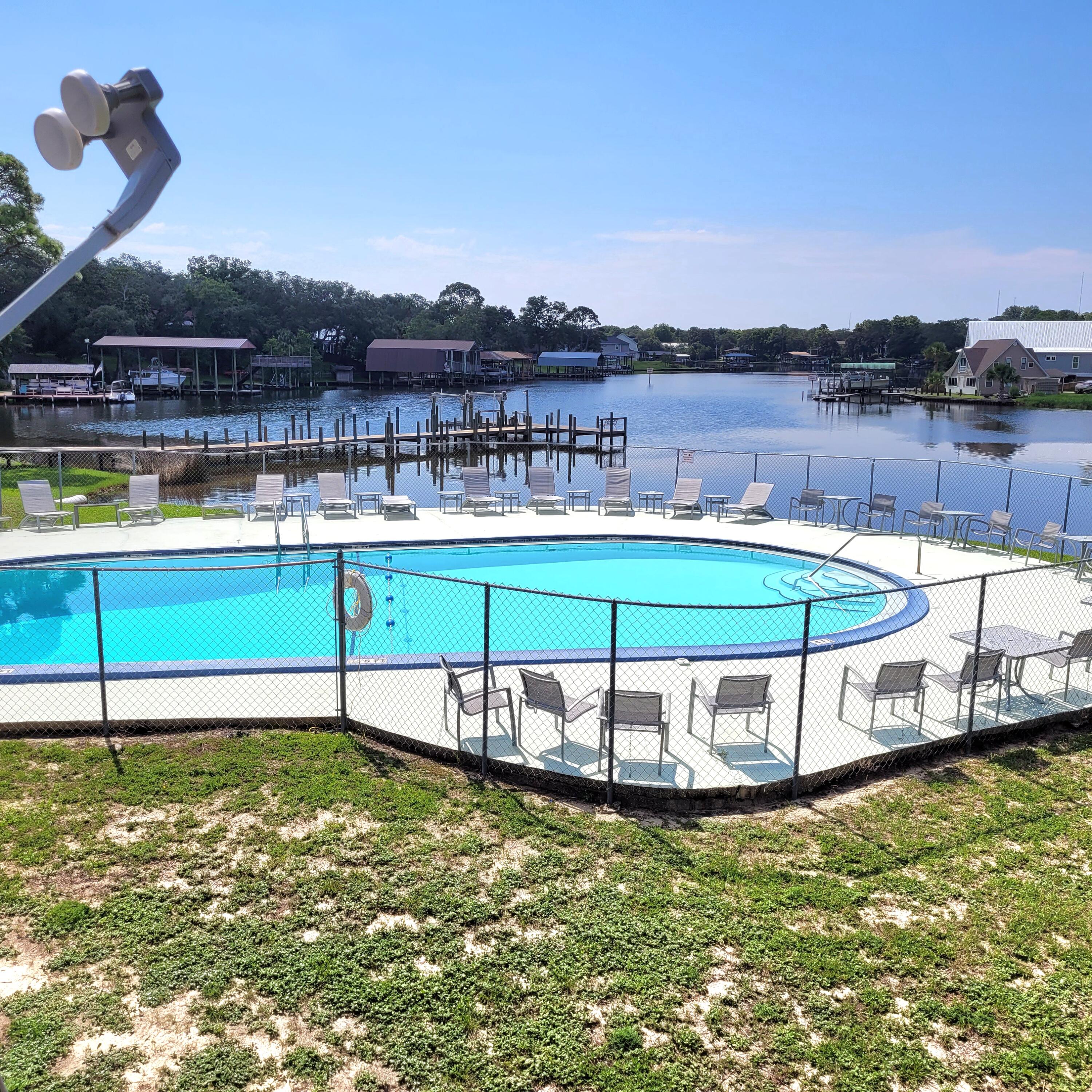 210 Pelham Road, Unit 208C Fort Walton Beach, FL 32547 - Photo 1 of 17 a view of a swimming pool with a lake view