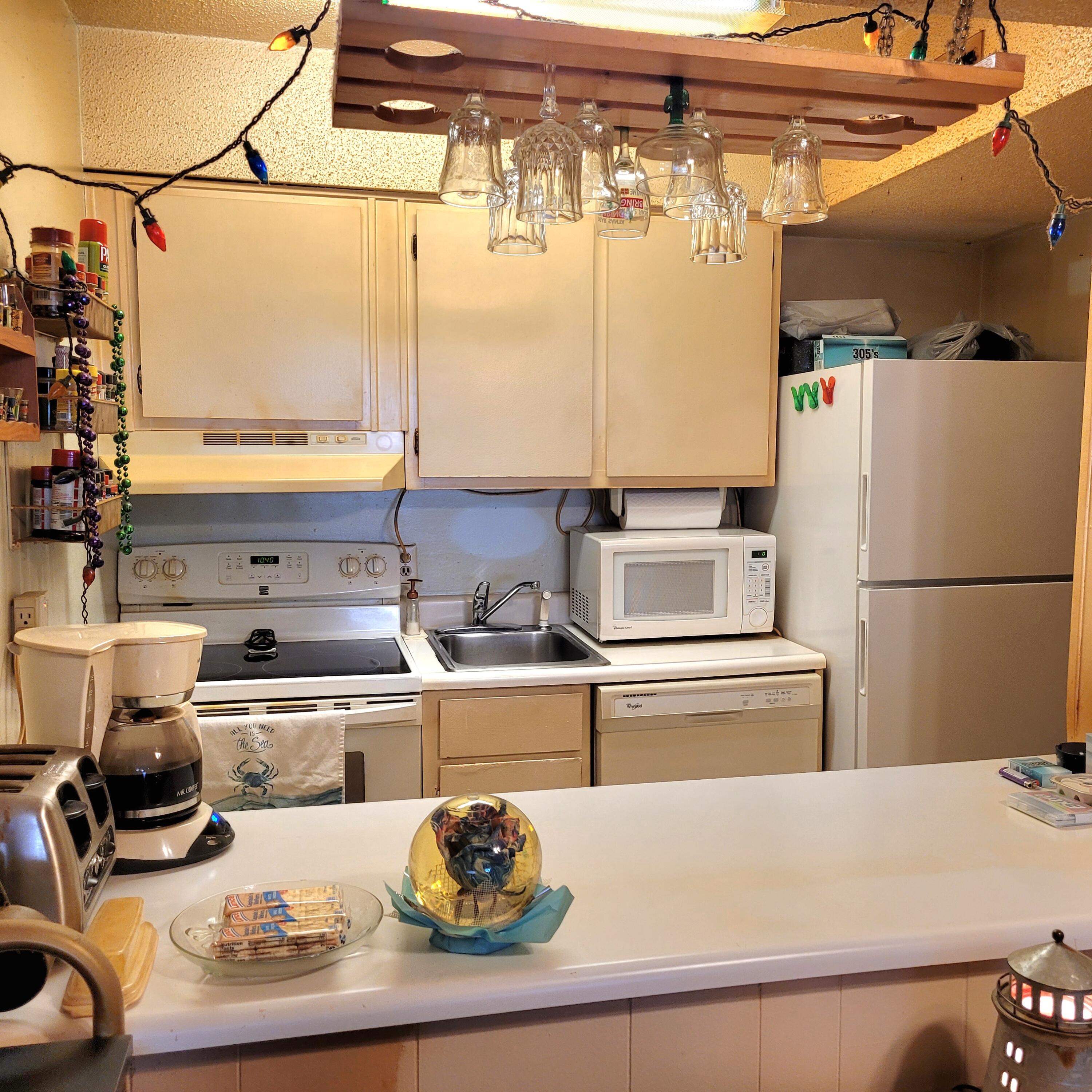 210 Pelham Road, Unit 208C Fort Walton Beach, FL 32547 - Photo 11 of 17 a kitchen with a refrigerator and a stove