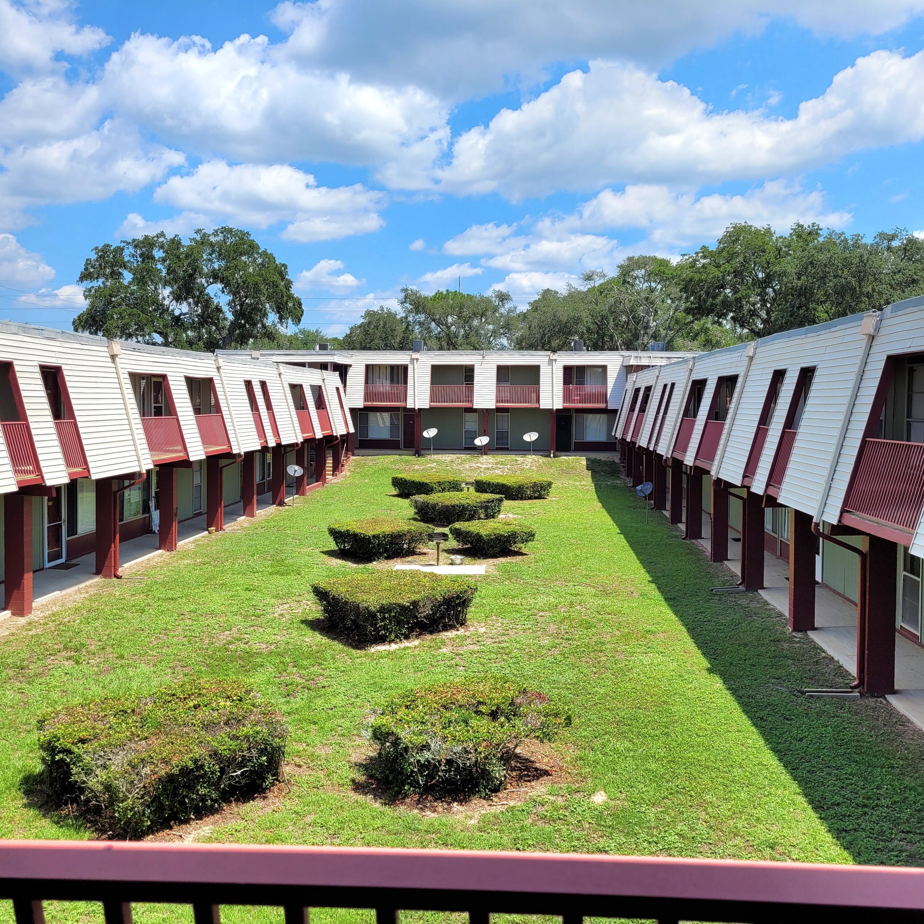 210 Pelham Road, Unit 208C Fort Walton Beach, FL 32547 - Photo 12 of 17 a view of swimming pool with a garden