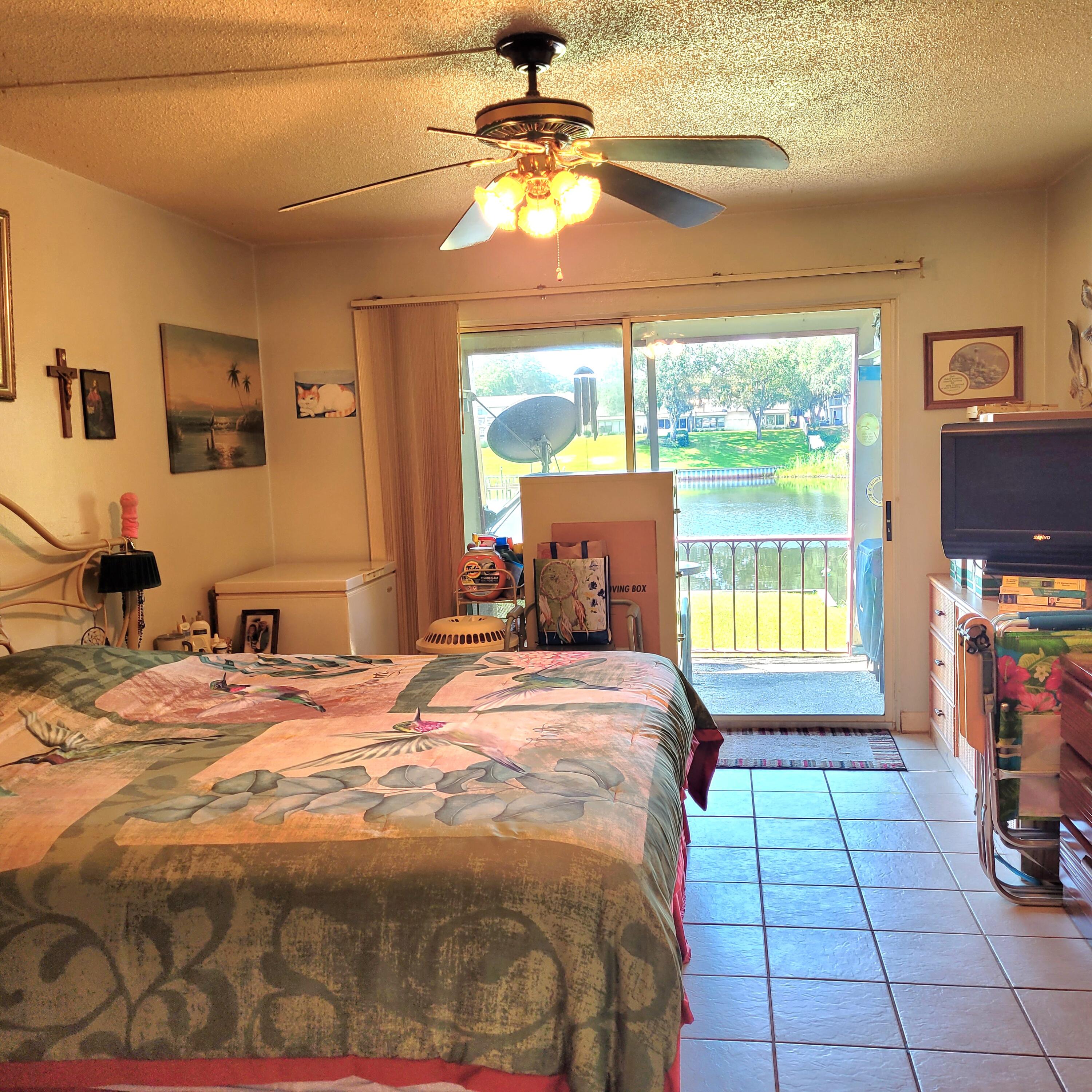 210 Pelham Road, Unit 208C Fort Walton Beach, FL 32547 - Photo 3 of 17 a bedroom with a bed and a chandelier