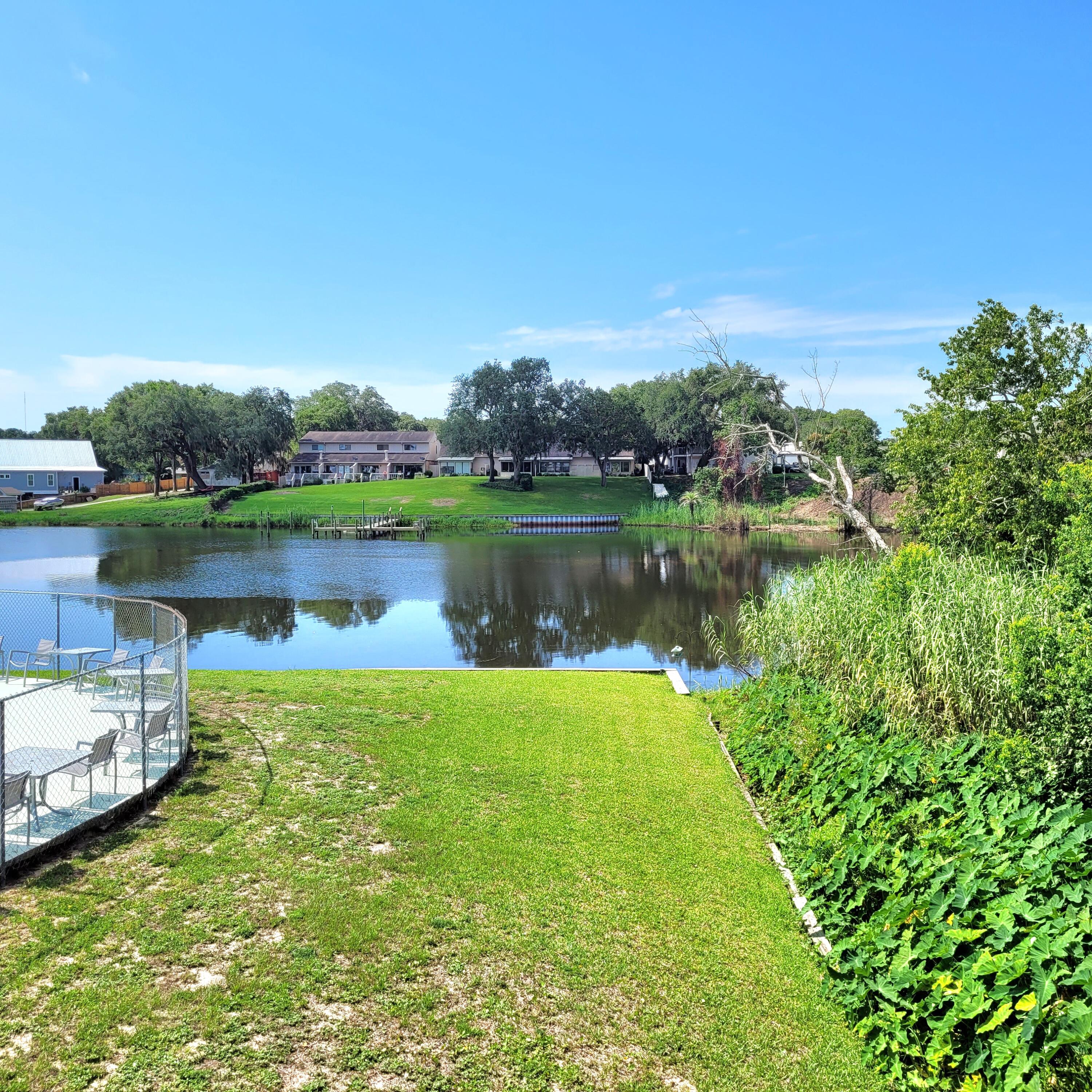 210 Pelham Road, Unit 208C Fort Walton Beach, FL 32547 - Photo 4 of 17 a view of a lake with houses in the back