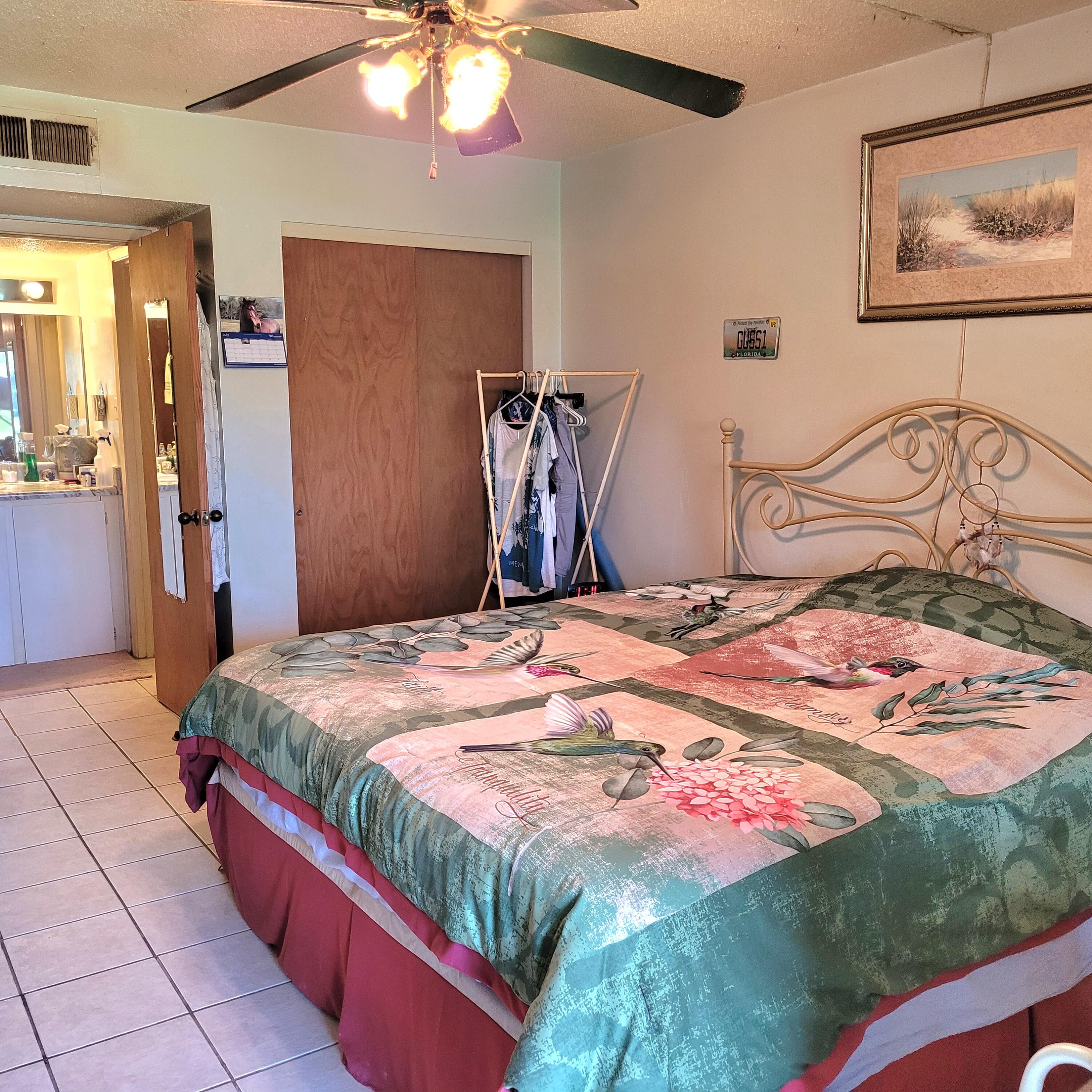 210 Pelham Road, Unit 208C Fort Walton Beach, FL 32547 - Photo 7 of 17 a bedroom with a bed and a chandelier