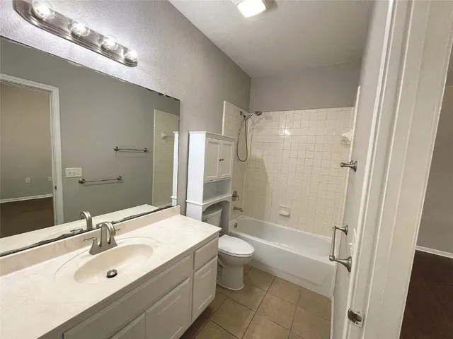 a bathroom with a double vanity sink toilet mirror and shower