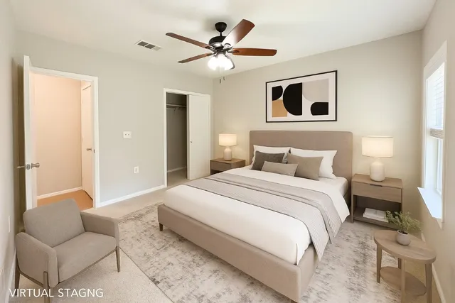 a bedroom with a bed couches and window