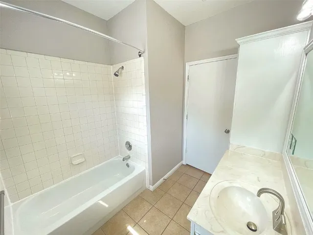 a bathroom with a tub and shower