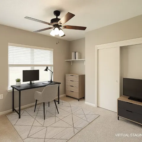 a workspace with a flat screen tv and a window