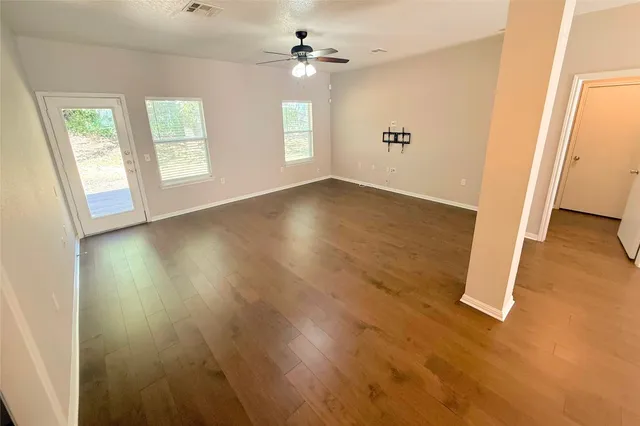 wooden floor in an empty room with a window