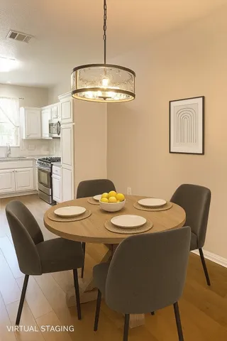 a dining room with a table and chairs
