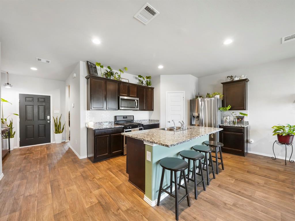 a large kitchen with a table and chairs in it