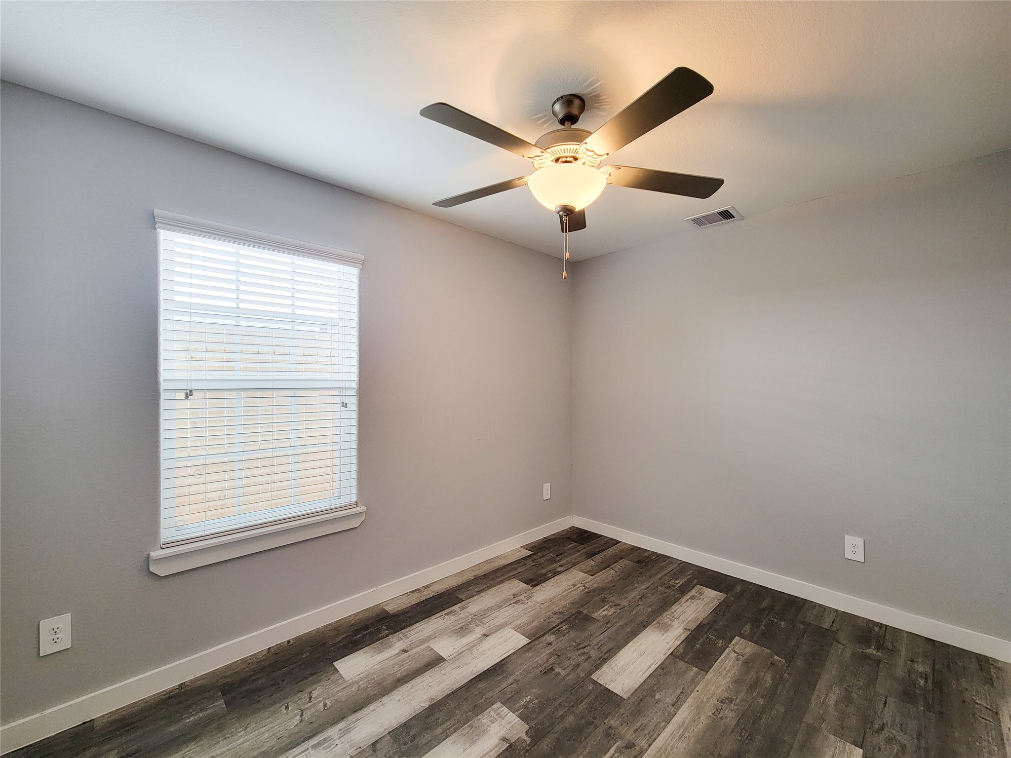 7202 Sandle Street, Unit A Houston, TX 77088 - Photo 11 of 29 an empty room with a window and a ceiling fan