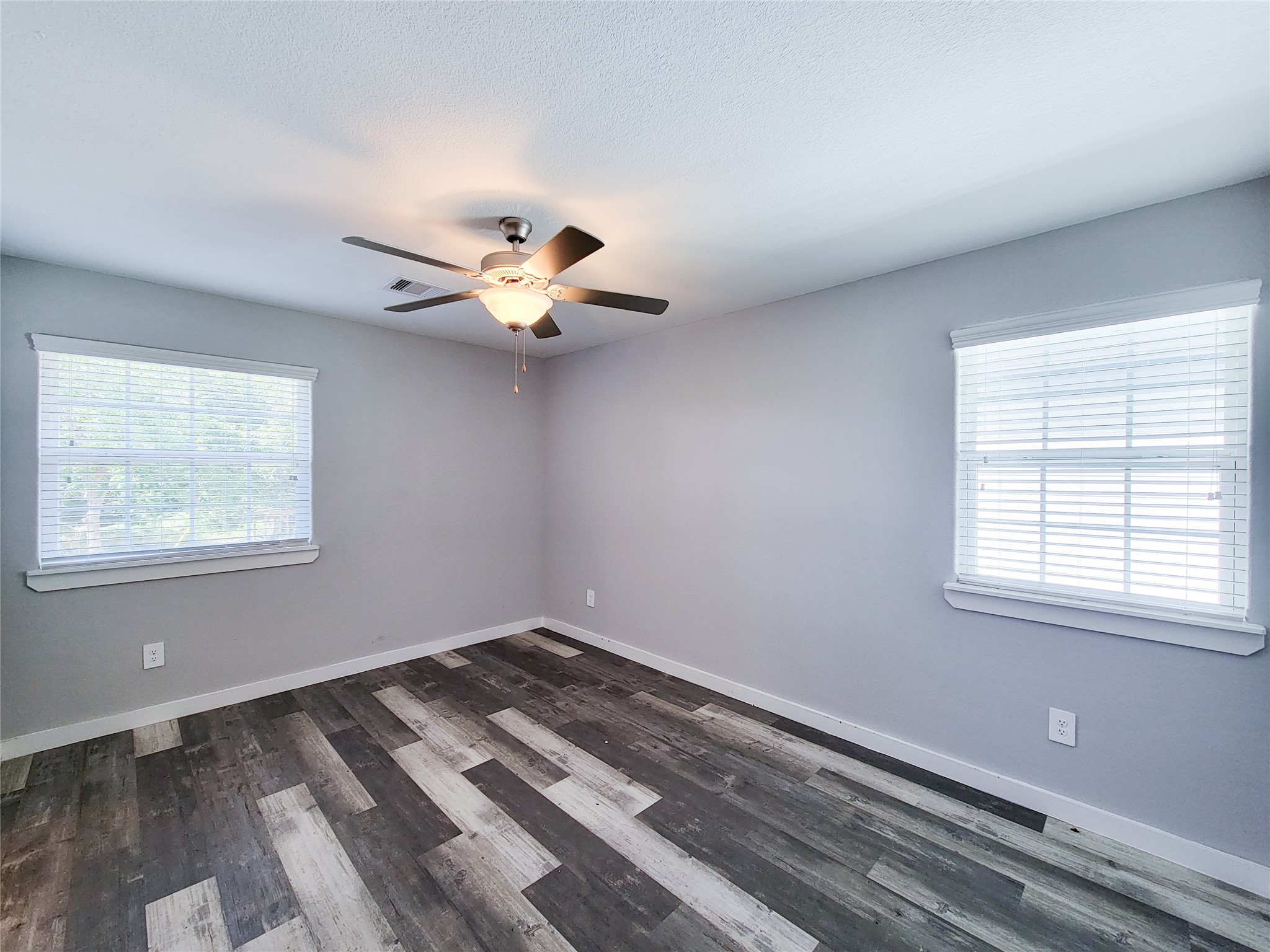 7202 Sandle Street, Unit A Houston, TX 77088 - Photo 16 of 29 a view of a room with a ceiling fan and window