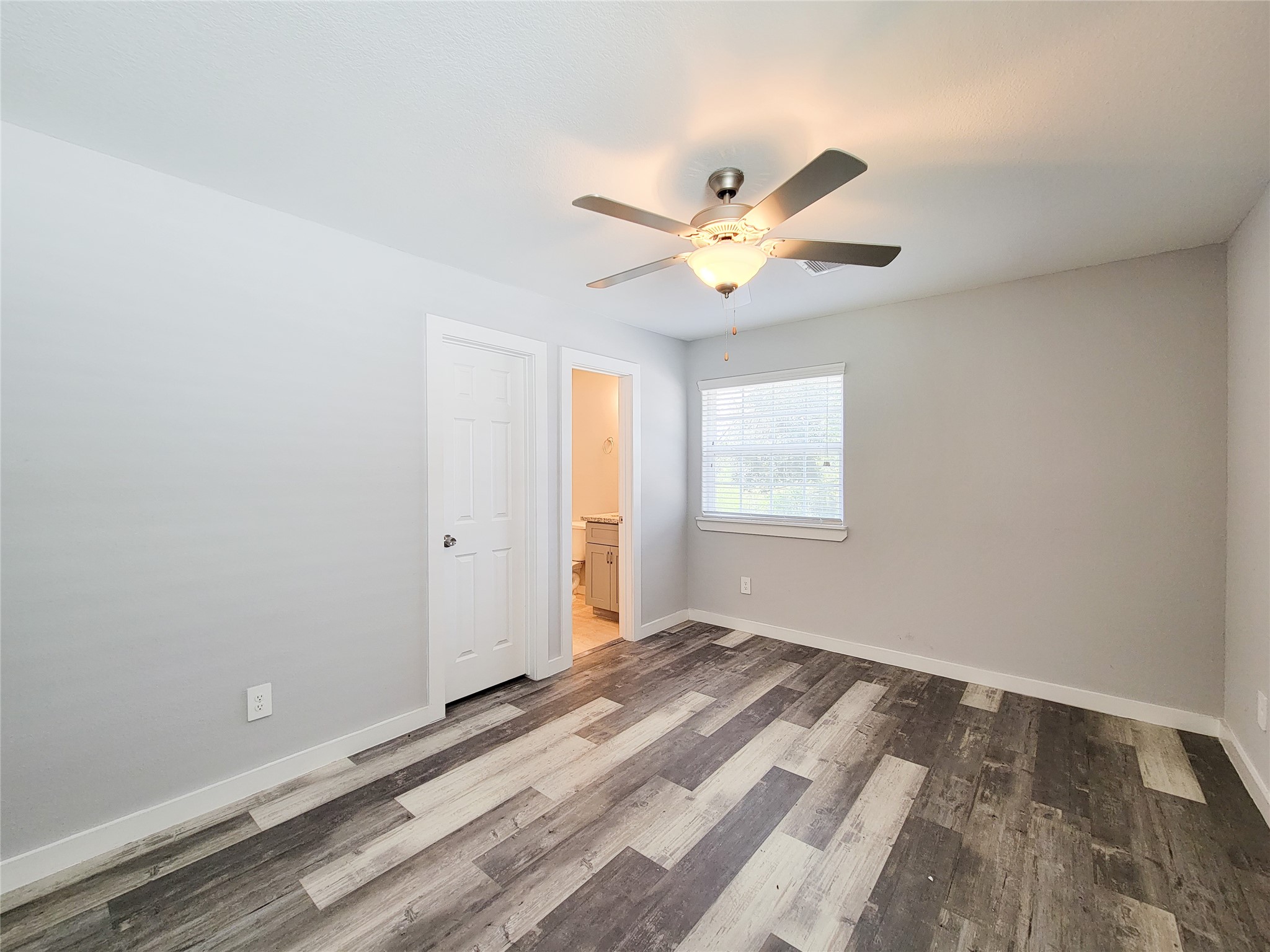 7202 Sandle Street, Unit A Houston, TX 77088 - Photo 17 of 29 an empty room with a window and a fan