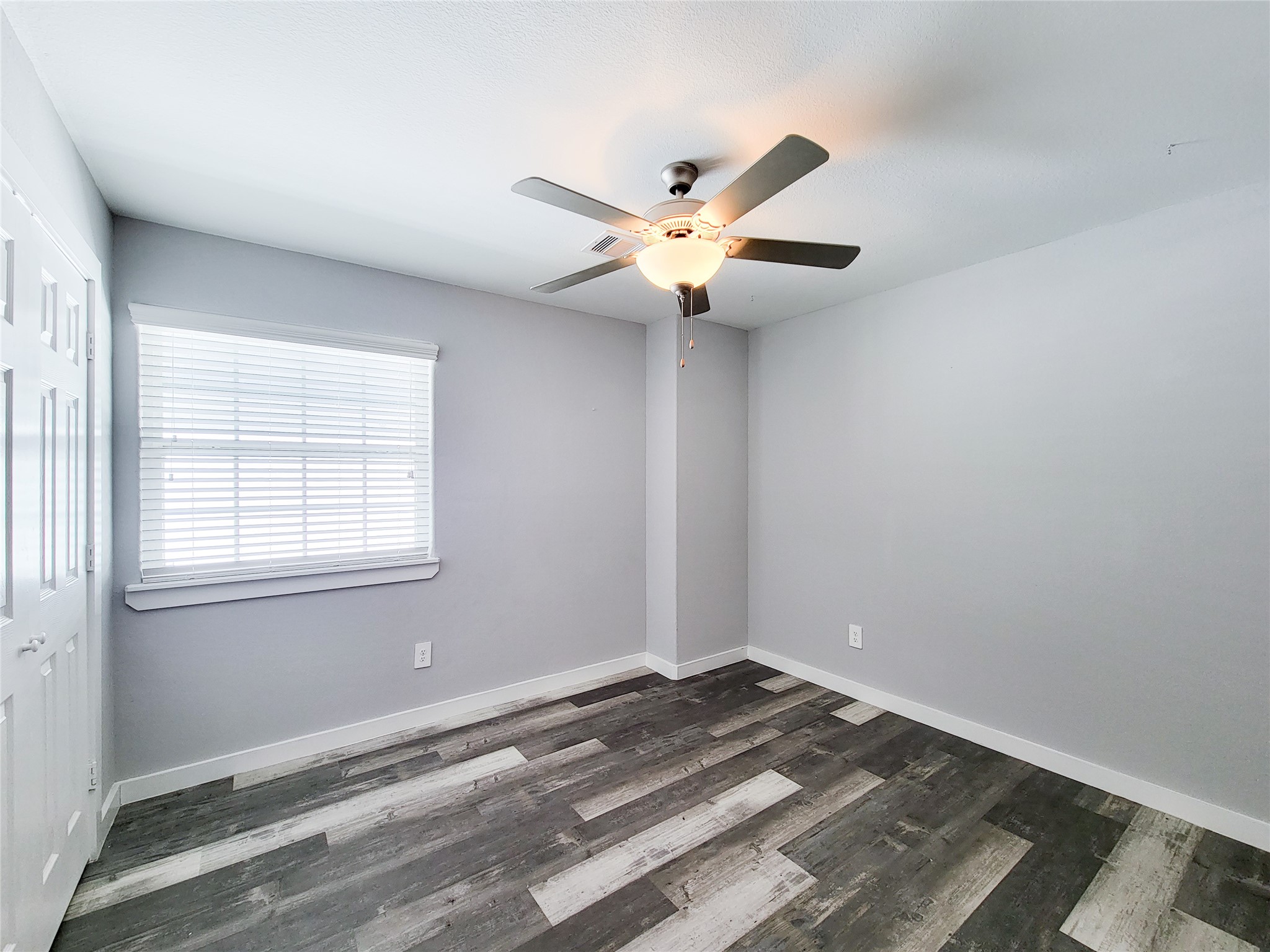 7202 Sandle Street, Unit A Houston, TX 77088 - Photo 18 of 29 a view of a room with a ceiling fan and a window