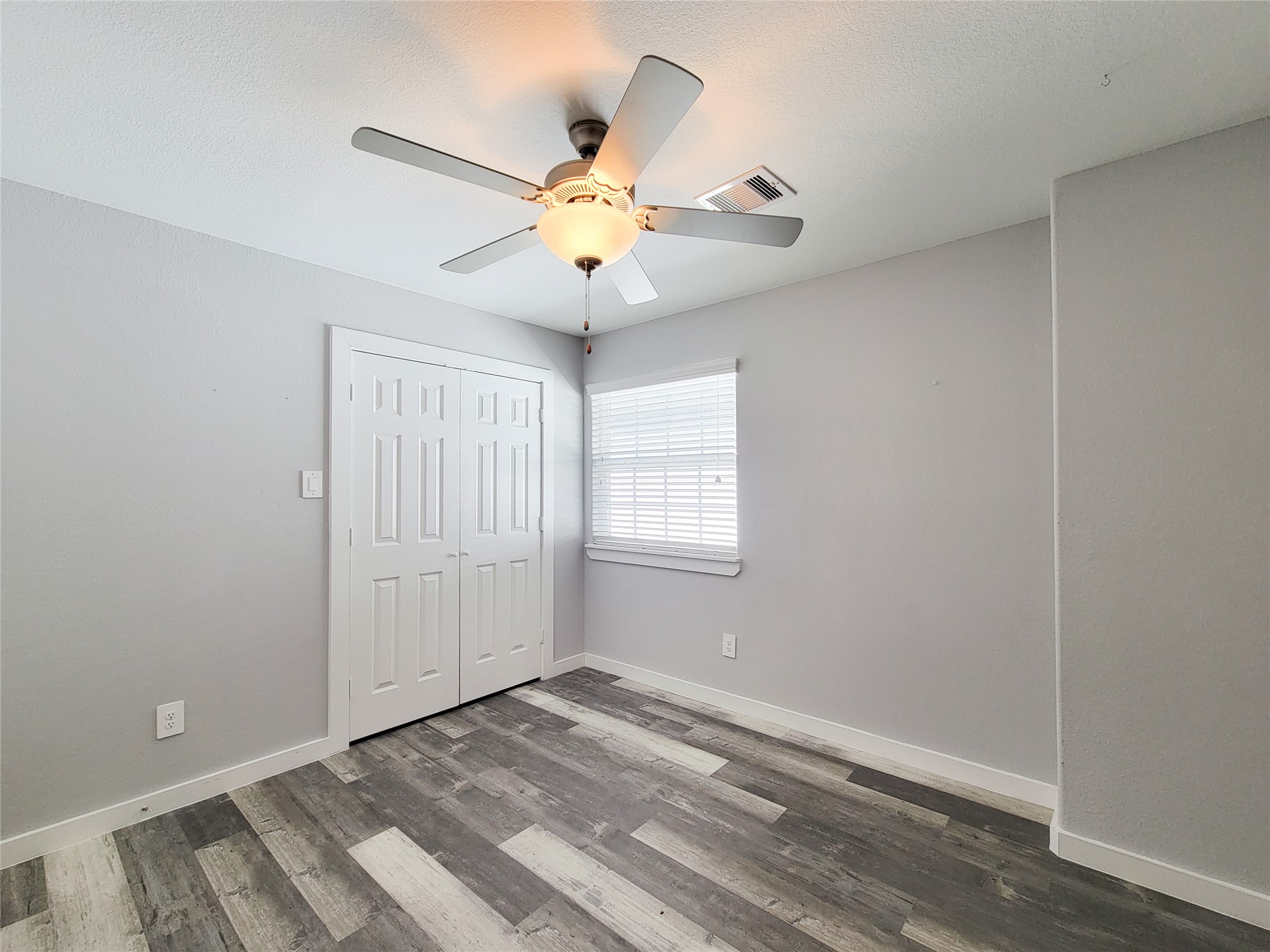 7202 Sandle Street, Unit A Houston, TX 77088 - Photo 19 of 29 wooden floor in an empty room with a window