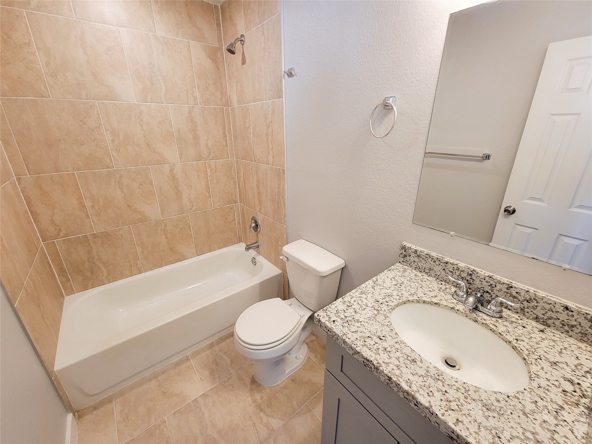 7202 Sandle Street, Unit A Houston, TX 77088 - Photo 25 of 29 a bathroom with a granite countertop toilet sink and mirror