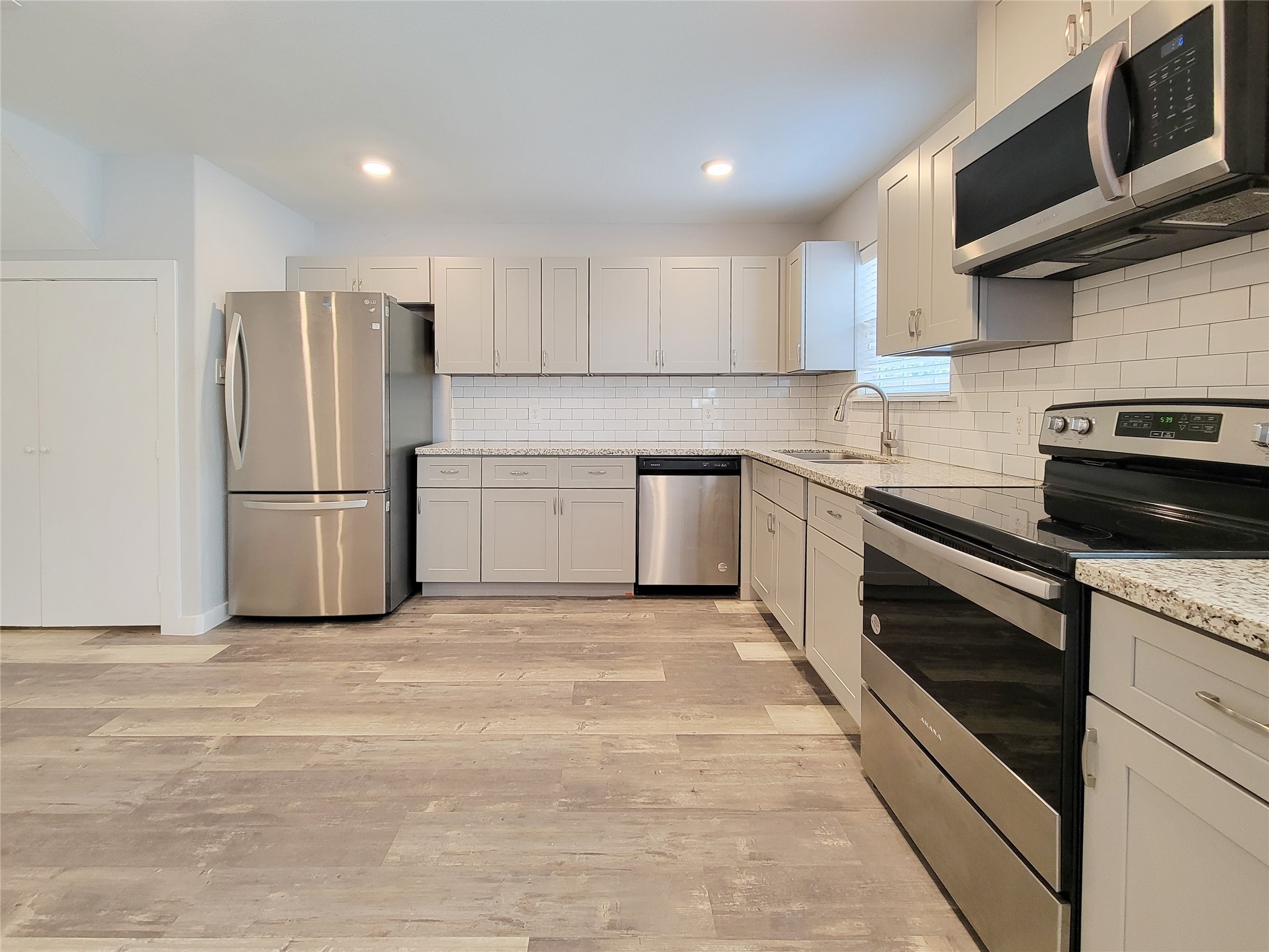 7202 Sandle Street, Unit A Houston, TX 77088 - Photo 9 of 29 a kitchen with stainless steel appliances granite countertop a refrigerator stove a sink and dishwasher