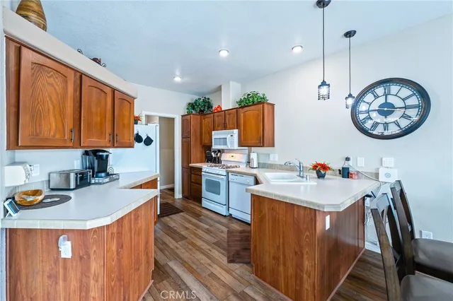 a kitchen with stainless steel appliances granite countertop a refrigerator and a stove