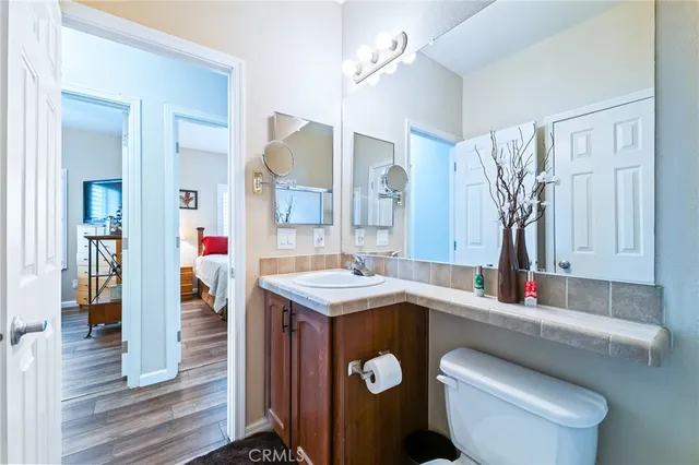 a view of a patio with table and chairs potted plants and a large tree
