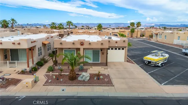 a view of a swimming pool with a lounge chair and chairs