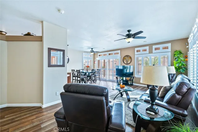 a living room with furniture a clock and a chandelier