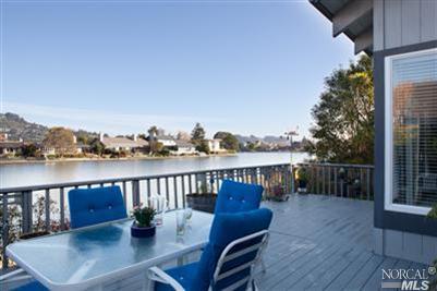 a view of a balcony with two chairs and a table