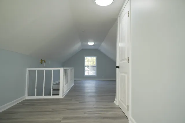 a view of entryway and hall with wooden floor
