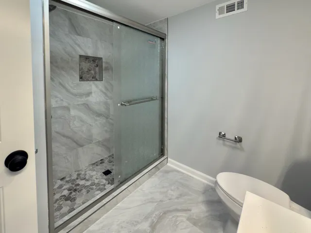 a bathroom with a bathtub and shower