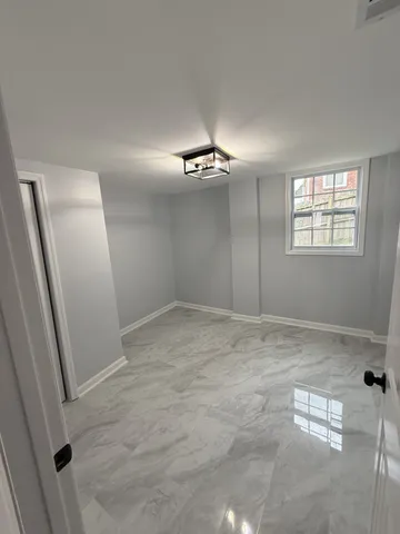 an empty room with windows and closet