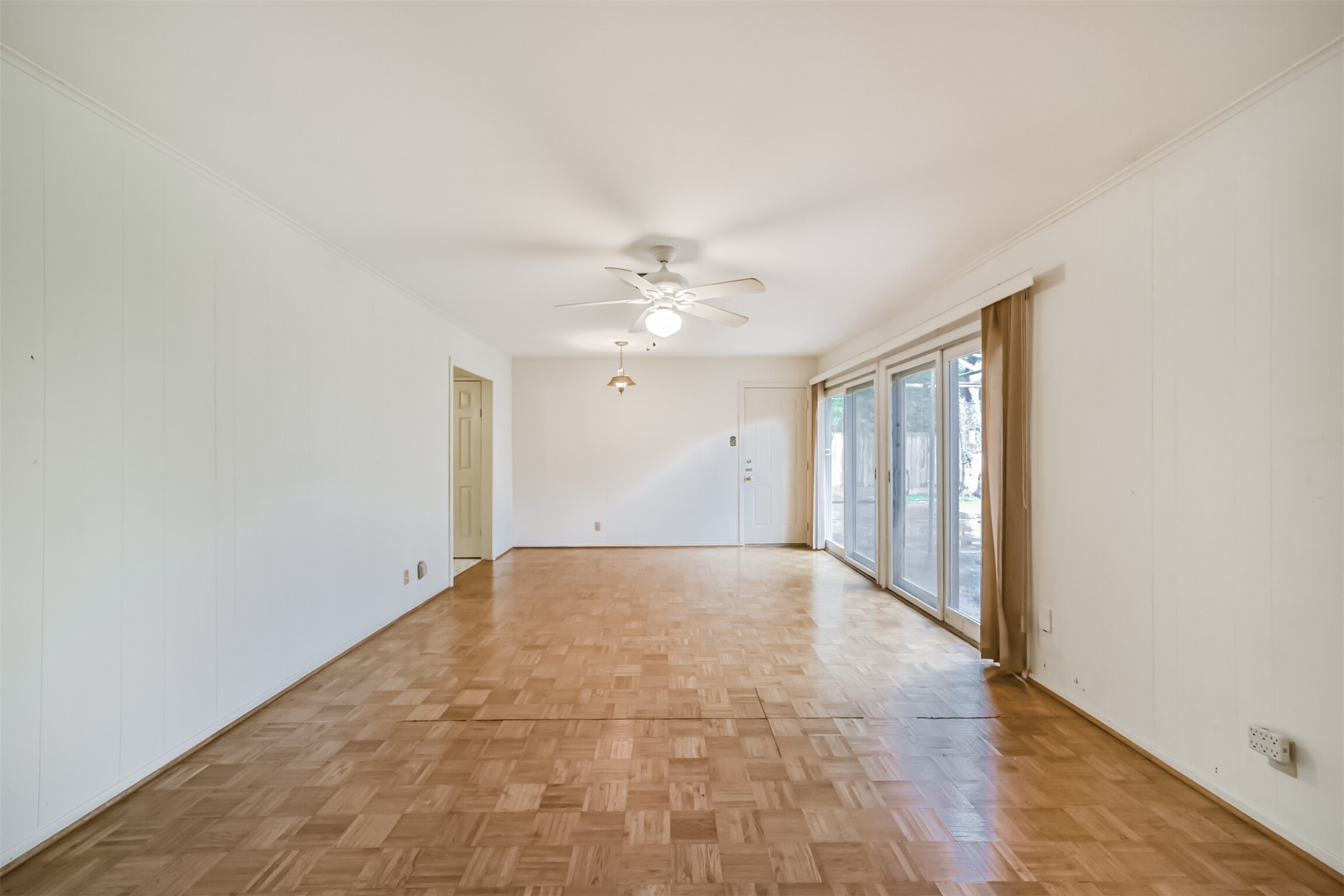 7510 Romney Road Houston, TX 77036 - Photo 10 of 32 This den has an abundance of natural light and parquet flooring.