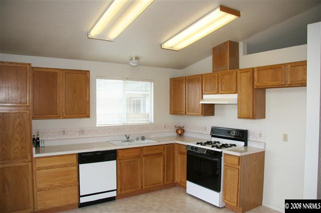 1622 Calusa Lane Reno, NV 89523 - Photo 2 of 9 a kitchen with stainless steel appliances granite countertop a sink and a stove
