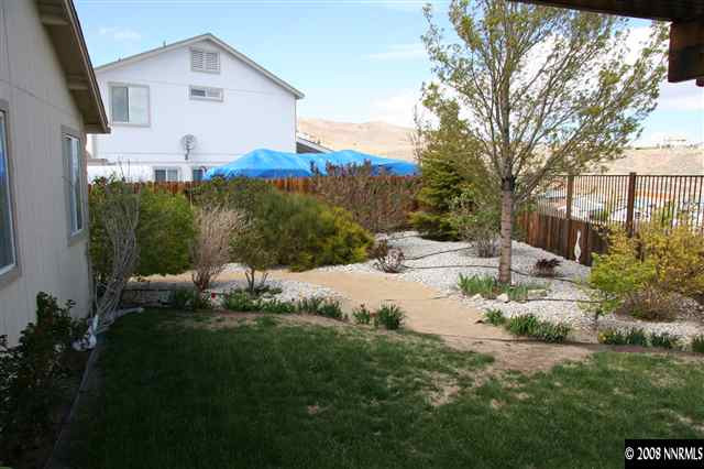 1622 Calusa Lane Reno, NV 89523 - Photo 8 of 9 a view of a white house with a yard and sitting area